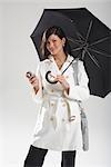 Portrait of Businesswoman Holding Umbrella and Sending Text Message