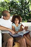 Father Reading Book with Daughter