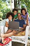 Portrait of Father with Laptop Surrounded by Children