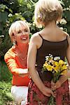 Girl Giving Flowers to Woman