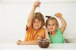 Children With Bowl of Chocolate Sauce