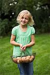 Portrait of Girl Holding Basket of Eggs