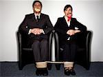 Male and female business people gagged and tied