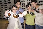 Two couples posing with sunglasses in store
