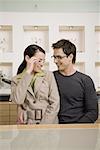 Couple posing with eyeglasses in store