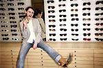 Woman posing in front of sunglasses display