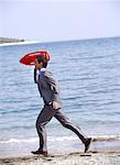 Businessman on beach with life preserver