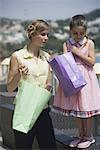 Mother and daughter looking in shopping bags