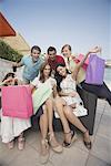 Group of friends with shopping bags posing