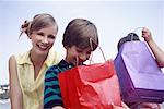 Mother and two children with shopping bags