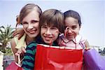 Mother and two children with shopping bags