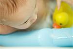 Baby taking bath, extreme close-up, cropped view