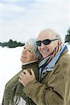 Senior couple embracing, smiling, outdoors, portrait
