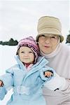 Grandmother and granddaughter smiling, dressed in winter clothing, portrait
