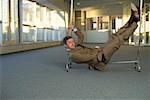 Businessman lying on a hallstand