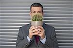 Businessman holding a cactus