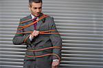 Businessman tied up with power cord