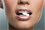 Woman with Pill in Mouth