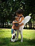 Girl and Boy Hugging in Yard