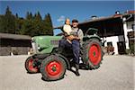 Farmer and Girl in Front of Tractor