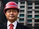 Businessman with construction helmet outdoors