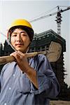 Construction worker outdoors with helmet smiling