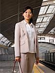 Businesswoman on subway platform smiling