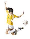 Teenage girl kicking soccer ball