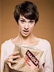 Woman holding crushed cardboard box with fragile label