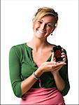 Woman with handheld electronic device smiling