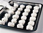 shaping meringues on a tray