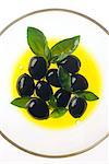 black olives in bowl of oil