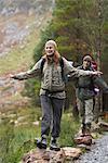 Couple Walking along Stones