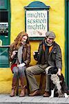 Couple Petting Dog by Pub, Ireland