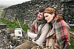 Couple Sitting by Stone Wall, Ireland