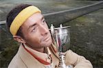 Close-up Portrait of Man Holding Trophy