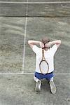 Tennis Player Kneeling on Tennis Court