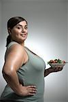 Woman holding bowl of salad