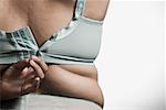 Woman fastening bra - Stock Photo - Masterfile - Premium Royalty