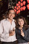 Portrait of a couple holding ice- cream cones and smiling