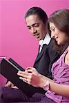 Couple looking at a menu and smiling