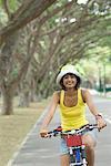 Portrait of a young woman riding a bicycle