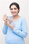 Portrait of a pregnant woman eating halwa