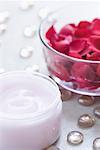 Close-up of rose petals in a bowl with moisturizer