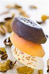 Close-up of a stack of soaps with herbs