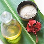 Close-up of spa treatment products on a banana leaf