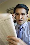 Close-up of a businessman reading a newspaper