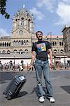 Tourist standing outside Railroad station, Chhatrapati Shivaji, Terminus, Mumbai, Maharashtra, India