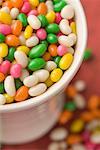 Close-up of a plastic glass filled with jellybeans