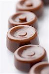 Close-up of brown candies in a row